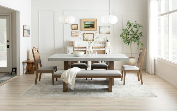 Monterey 7 Piece Natural & Gray Panel Back Upholstered Dining Set with faux concrete melamine table top, gray fabric polyester seats, and traditional rubberwood frame
