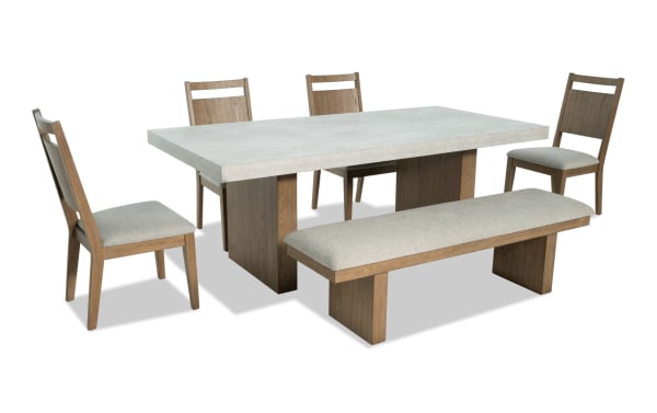 Monterey 6 Piece Natural & Gray Panel Back Upholstered Dining Set with Bench features a faux concrete melamine tabletop, gray polyester fabric seats, and a traditional wood frame. Includes four memory foam-filled chairs and a matching bench from the Monterey Dining collection.