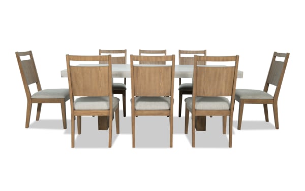 Monterey 9 Piece Natural & Gray Panel Back Upholstered Dining Set with faux concrete melamine table top, gray polyester fabric chairs, traditional style.