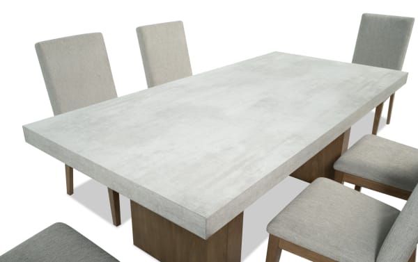 Monterey 7 Piece Natural & Gray Solid Back Upholstered Dining Set with gray fabric polyester chairs and faux concrete melamine table top in traditional style