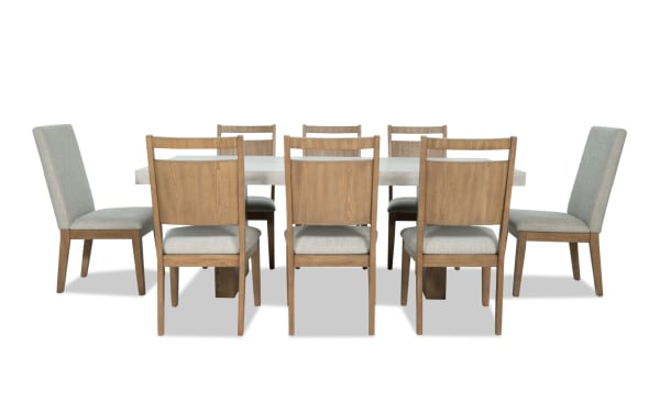 Monterey 9 Piece Natural & Gray Upholstered Dining Set with faux concrete melamine table top and eight gray polyester fabric chairs with memory foam.