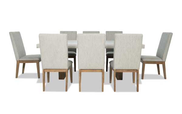 Monterey 9 Piece Natural & Gray Dining Set with gray fabric polyester upholstery, solid back chairs, and faux concrete melamine tabletop in traditional style.
