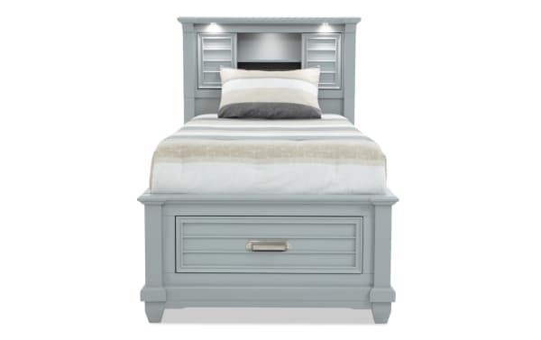 Sunset Cove Youth Twin gray bookcase storage bed in coastal style, MDF construction, with built-in storage drawer, LED lighting, and USB/USB-C ports.