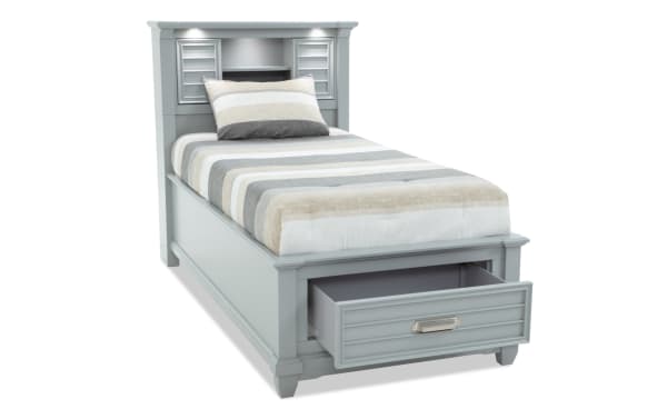 Sunset Cove Youth Twin Gray Bookcase Storage Bed in coastal style, MDF construction, with built-in storage drawer, LED lighting, and USB-C ports.