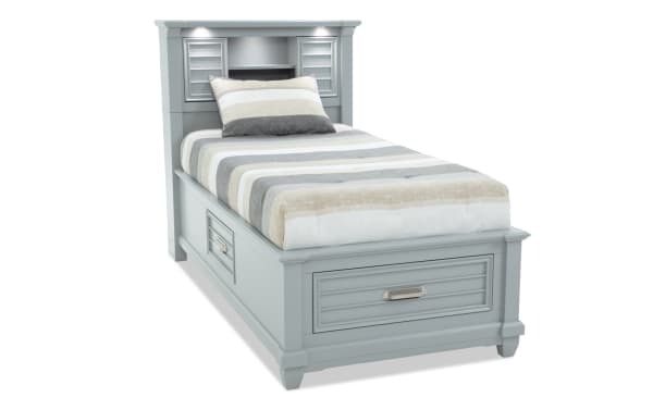 Sunset Cove Youth Twin Gray Bookcase Storage Bed in coastal style with MDF construction, built-in LED lights, USB ports, and three smooth-glide drawers.