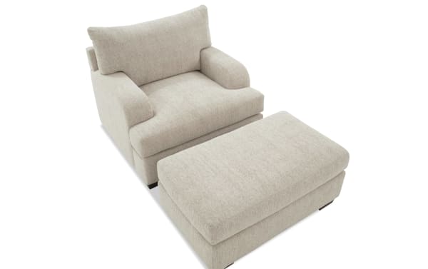 Transitional Cypress Beige Chair & Ottoman set upholstered in soft polyester fabric, featuring plush cushions and Bob-O-Pedic® Memory Foam for ultimate comfort.