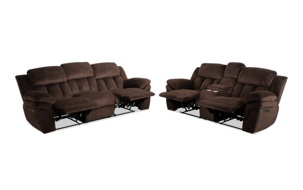 Brown fabric reclining living room sofa set featuring plush cushions, padded armrests, and cup holders, designed for comfort and relaxation.