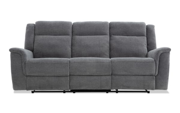 Gray fabric reclining sofa with three seats, padded armrests, and cushioned backrests, designed for living room comfort and style.