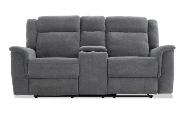 Gray fabric reclining loveseat with center console and cup holders, featuring padded armrests and cushioned back support for living room comfort.