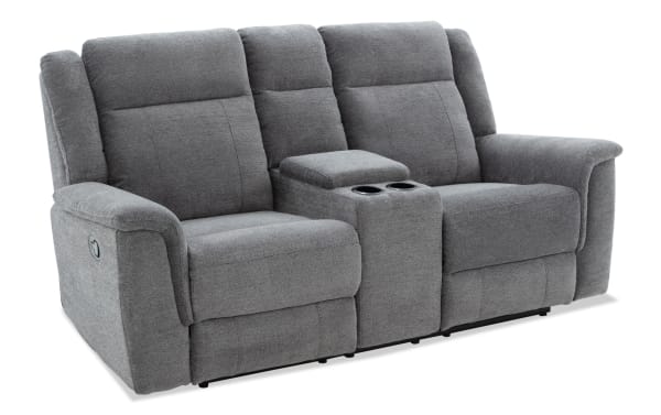 Gray fabric reclining loveseat with center console featuring cup holders and padded armrests, designed for living room comfort and relaxation.
