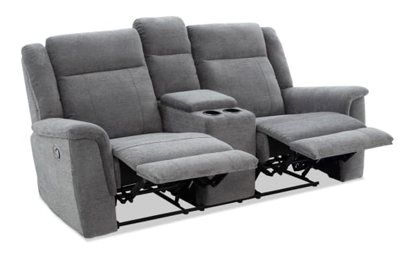 Gray fabric reclining loveseat with center console, cup holders, padded armrests, and plush cushioning for living room comfort.