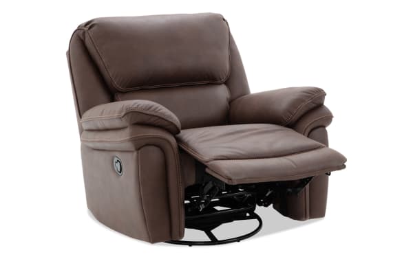 Brown leather recliner chair with padded armrests and cushioned backrest, featuring a manual lever for reclining and footrest extension.