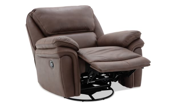 Brown leather recliner chair with padded armrests and cushioned backrest, featuring a manual lever for reclining and a footrest extension.