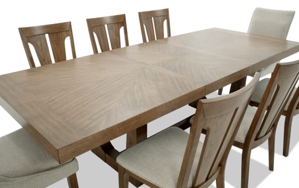 Melrose 9 Piece Natural & Beige Upholstered Extendable Dining Set with rectangular wood table, fabric polyester chairs, and memory foam seats.