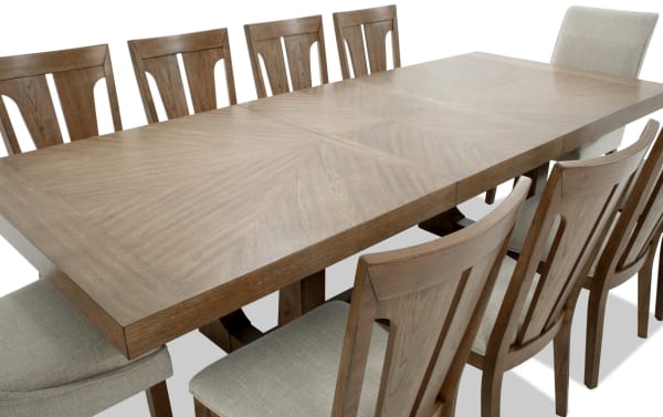 Melrose 11 Piece Natural & Beige Upholstered Extendable Dining Set with MDF, rubberwood, hickory veneer, and polyester fabric chairs, transitional style.