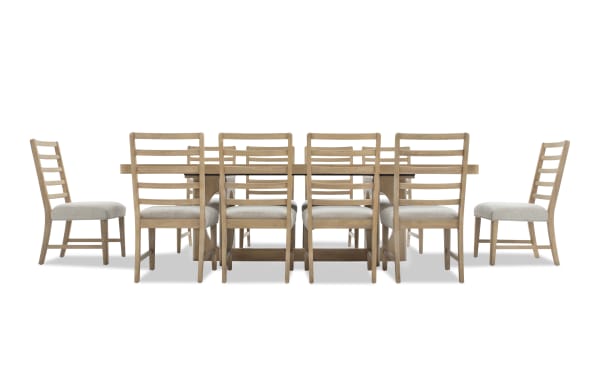 Dining set with a rectangular wooden table and eight ladder-back chairs featuring light beige upholstered seats and natural wood finish.