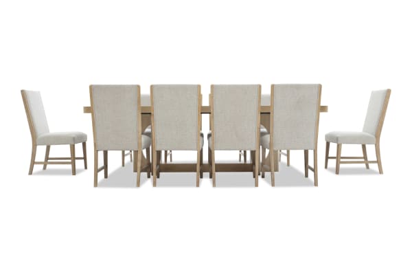 Dining set with a large rectangular wooden table and ten beige upholstered chairs featuring wooden legs and high backs, suitable for modern dining rooms.