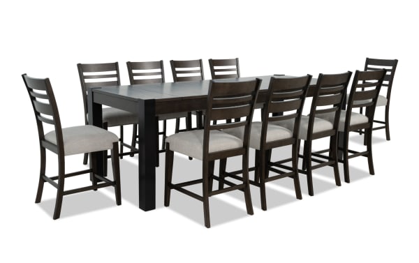 Aurora 11 Piece Brown & Black Ladder Back Extendable Counter Height Dining Set with gray polyester fabric seats, MDF and rubberwood solids, transitional style, featuring an 86'' to 102'' extendable table with two lift-top storage compartments.