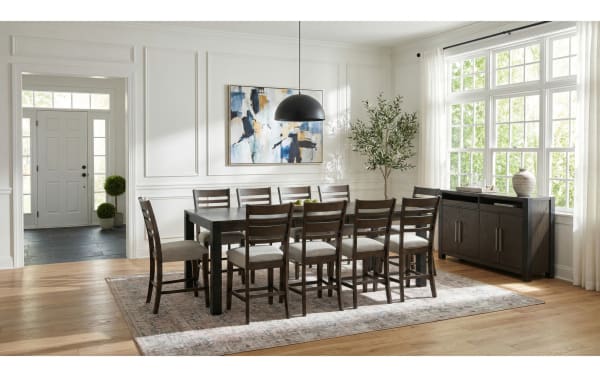 Aurora 11 Piece Brown & Black Ladder Back Extendable Storage Counter Height Dining Set in gray polyester fabric with MDF and rubberwood solids, transitional style, featuring an 86'' to 102'' extendable table with dual lift-top storage compartments and cushioned ladder back chairs.