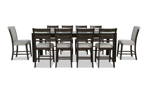 Aurora 11-piece transitional dining set in gray fabric polyester upholstery with brown rubberwood frame, extendable 86"-102" table, and storage compartments.
