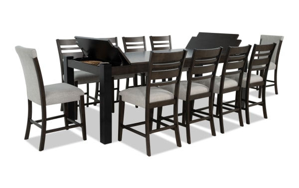 Aurora 11 Piece Brown & Black Upholstered Extendable Storage Counter Height Dining Set with gray polyester fabric seats, MDF and rubberwood solids, transitional style, featuring lift-top storage compartments and memory foam stools.