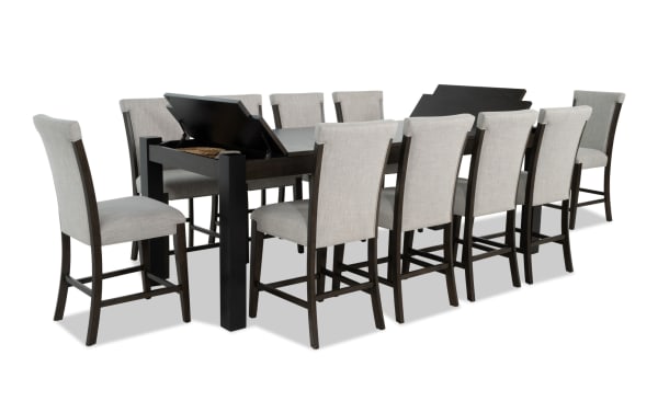 Aurora 11 Piece Brown & Black Extendable Storage Counter Height Dining Set with gray polyester fabric upholstery, MDF and rubberwood solids, transitional style, featuring two lift-top storage compartments and Bob-O-Pedic® Memory Foam stools.