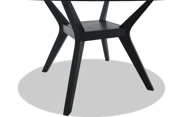 Black wooden table legs with a sturdy crossbar support and angled design, showcasing modern furniture craftsmanship and stability.