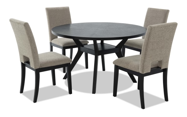 Round black wooden dining table with four beige upholstered chairs featuring black wooden legs, modern style for dining room seating.
