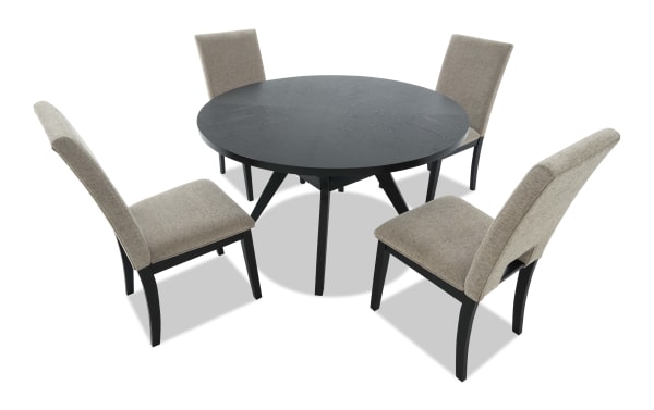 Round black wooden dining table with four beige upholstered high-back chairs, modern style, suitable for kitchen or dining room.