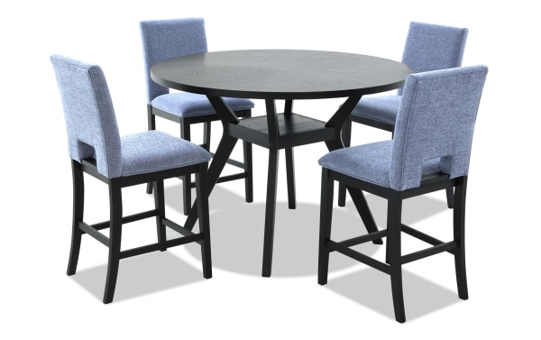 Round black wooden dining table with four blue upholstered high-back chairs, featuring cushioned seats and modern design.
