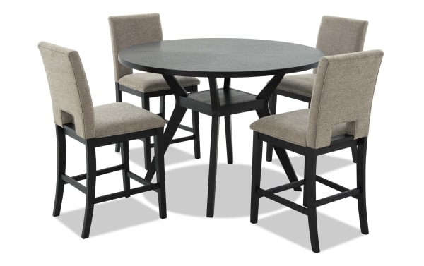 Round black wood dining table with four beige upholstered high-back chairs, featuring cushioned seats and sturdy black wooden legs, suitable for modern dining rooms.