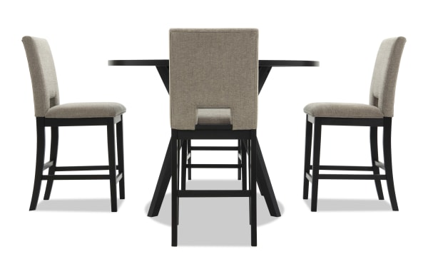 Dining set with a round black wood table and four beige upholstered chairs featuring black wooden legs and cushioned seats.