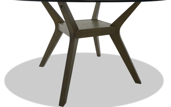 Dark wood table legs with angled design and a central support shelf, showcasing mid-century modern style and sturdy construction.