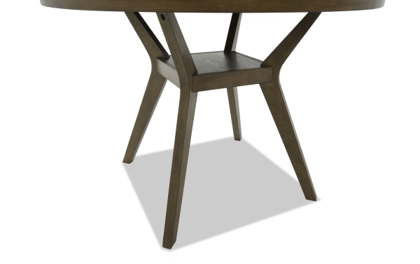 Round wooden table base with angled legs and a small central shelf, featuring a dark brown finish and modern design.