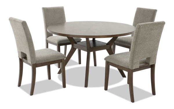 Round wooden dining table with a dark brown finish, featuring a central support shelf and four beige upholstered chairs with wooden legs, suitable for modern dining rooms.