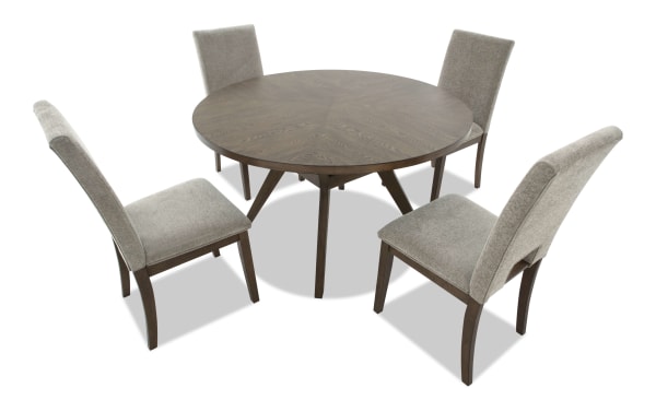 Round wooden dining table with a dark brown finish and four beige upholstered chairs with wooden legs, modern style.
