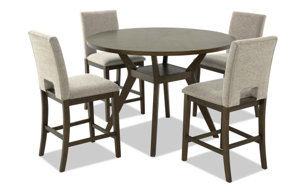 Round wooden dining table set with four beige upholstered high-back chairs, featuring dark wood frames and modern design, suitable for kitchen or dining room.