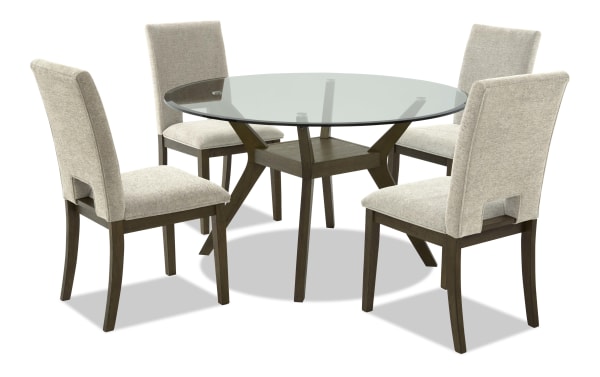 Round dining table set with a glass top and dark wood base, paired with four beige upholstered chairs with wooden legs, modern style.