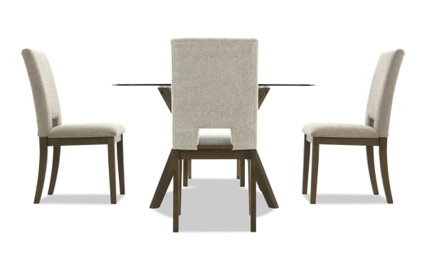Dining set with a rectangular glass top table and four beige upholstered chairs featuring wooden legs and a modern design.