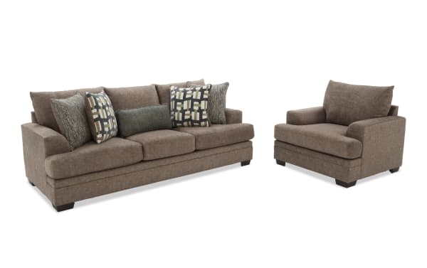 Brown fabric living room set with a three-seater sofa and a matching armchair, featuring plush cushions and patterned throw pillows.