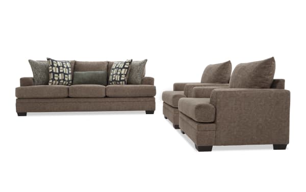 Brown fabric living room set including a three-seat sofa and two armchairs with patterned and solid accent pillows, featuring dark wooden legs and plush cushions.