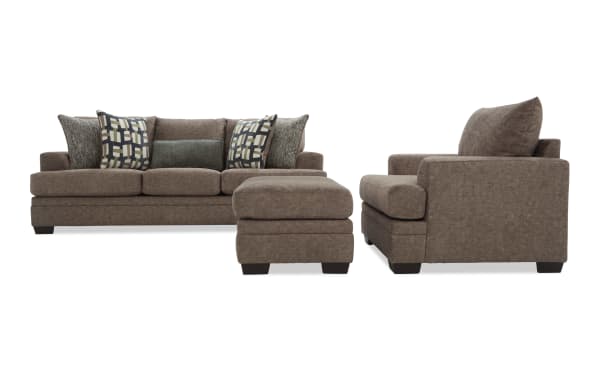 Brown fabric sofa set with three-seat couch, matching ottoman, and armchair, featuring patterned and textured throw pillows, modern design.