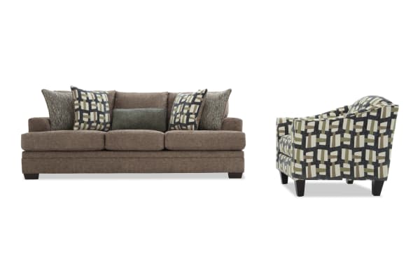 Brown fabric sofa with three seat cushions and five decorative pillows, paired with a patterned armchair featuring geometric designs in beige, green, and black.