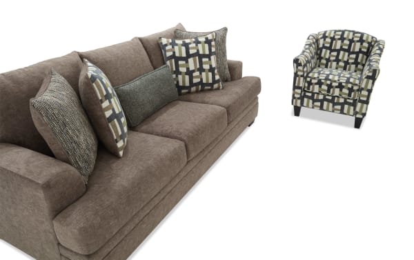 Brown fabric sofa with multiple patterned cushions paired with a matching geometric-patterned armchair, showcasing modern living room furniture.
