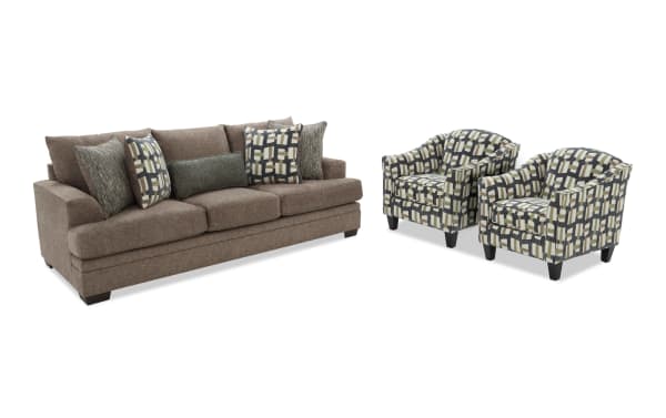 Brown fabric sofa with three seat cushions and five decorative pillows, paired with two patterned fabric armchairs featuring geometric designs and dark wooden legs.
