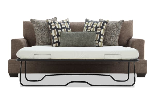 Brown fabric sofa with a pull-out metal frame bed and white mattress, featuring five decorative patterned cushions for added comfort and style.