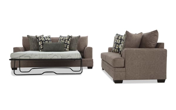 Brown fabric sofa sleeper with geometric and textured throw pillows, featuring a pull-out mattress and sturdy black metal frame, modern style.
