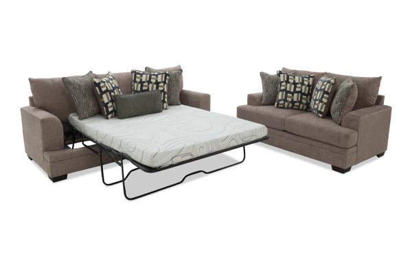 Brown fabric sectional sofa with pull-out queen-size mattress bed, multiple patterned cushions, and sturdy black metal frame for space-saving comfort.