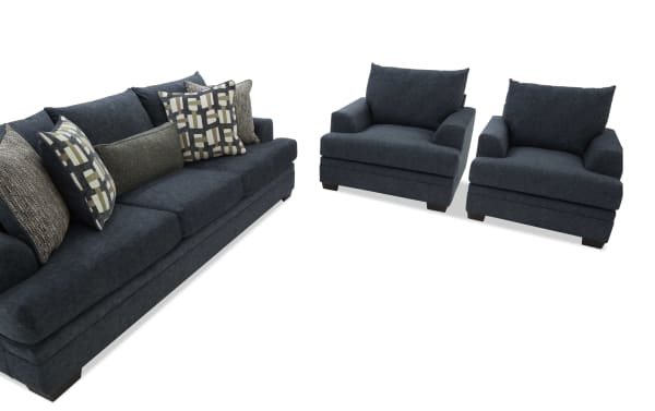 Dark blue fabric sofa set with a three-seater couch and two matching armchairs, featuring multiple patterned and textured throw pillows.
