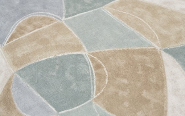 Contemporary Sydney Multicolored Pouf with abstract geometric pattern in muted blues and beiges, made of durable polyester fabric upholstery.